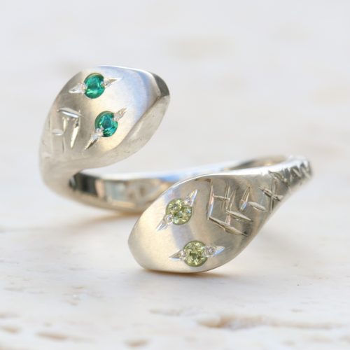sterling silver double headed snake ring with emerald and peridot eyes