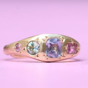 gold engagement ring with pastel coloured stones