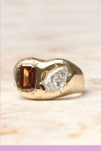 yellow gold engagement ring with orange emerald cut lab grown diamond and pear lab grown diamond